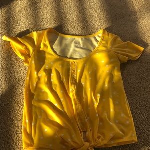 A relaxed yellow button up T-shirt